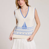 Knitted Vest With A Blue Sailboat Pattern Paired