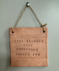 "don't stumble over something behind you" Hanging Wall Sign