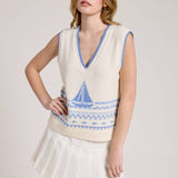 Knitted Vest With A Blue Sailboat Pattern Paired