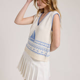 Knitted Vest With A Blue Sailboat Pattern Paired