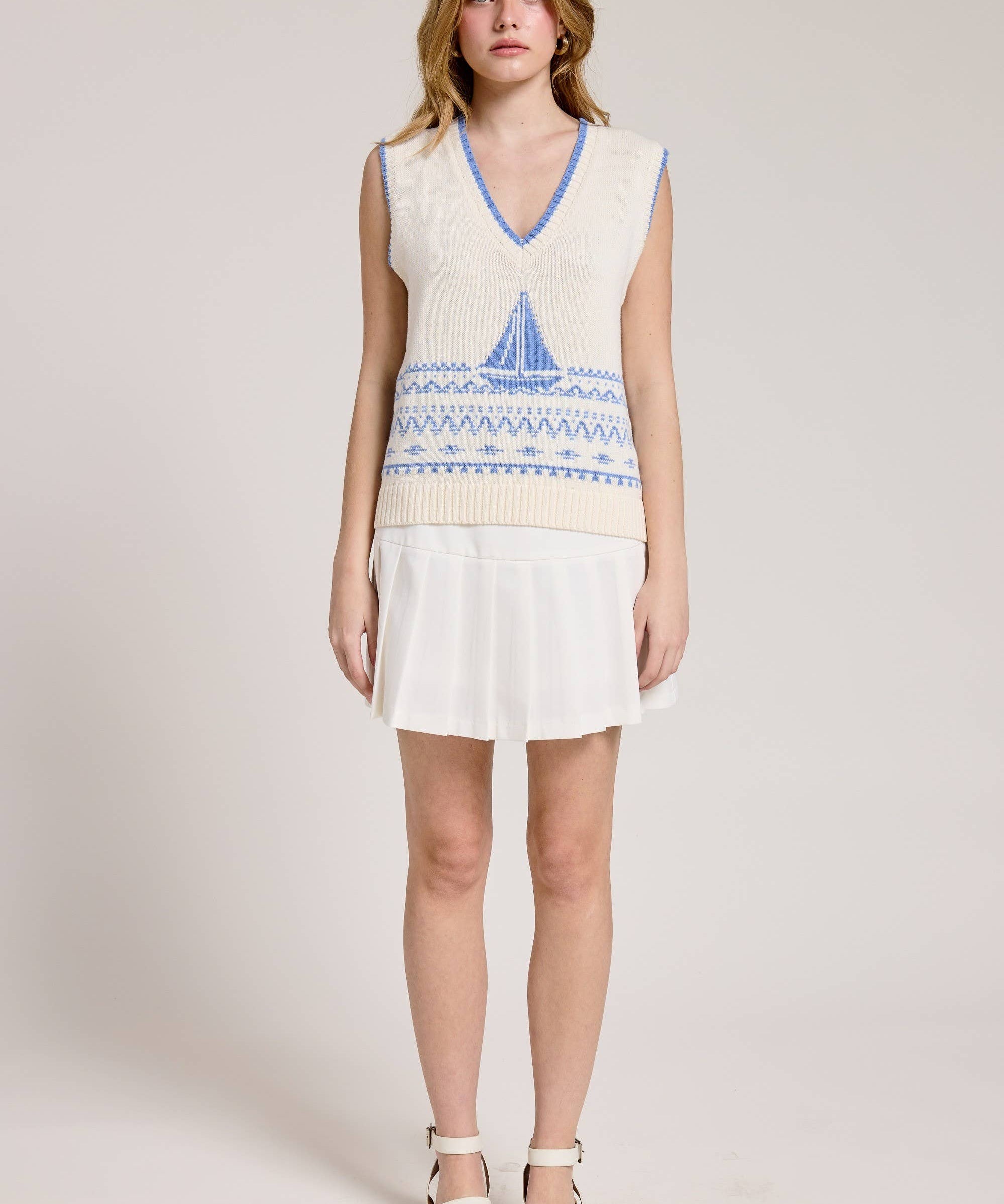 Knitted Vest With A Blue Sailboat Pattern Paired