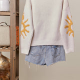 Cozy Knit Sweater with Bold Yellow Sun Patch