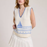 Knitted Vest With A Blue Sailboat Pattern Paired