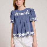 Embroidered Blouse With White Denim Shorts.