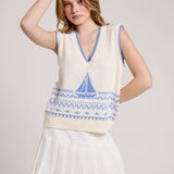Knitted Vest With A Blue Sailboat Pattern Paired