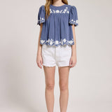 Embroidered Blouse With White Denim Shorts.