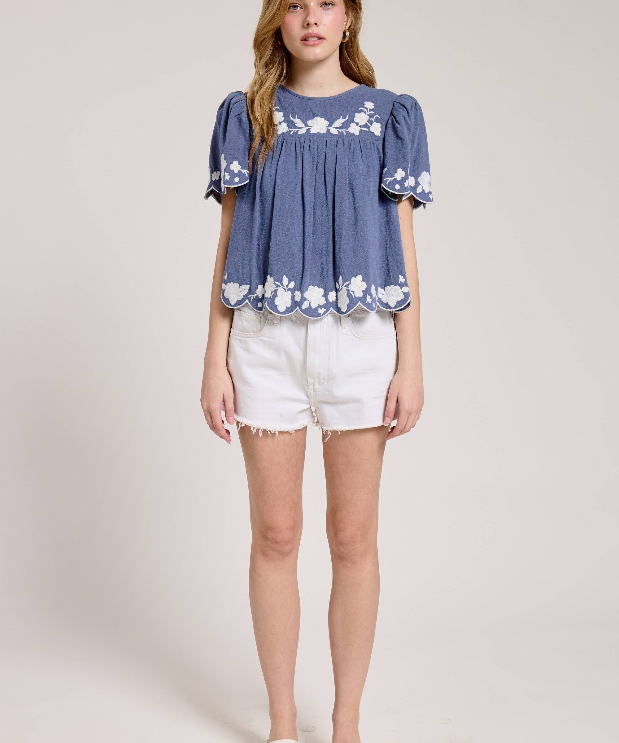 Embroidered Blouse With White Denim Shorts.