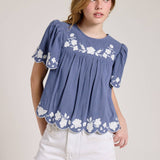 Embroidered Blouse With White Denim Shorts.