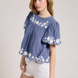 Embroidered Blouse With White Denim Shorts.